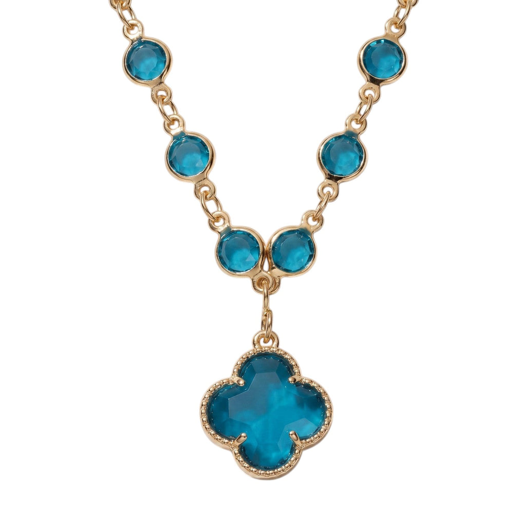 KEVOUR 18K gold-filled station necklace featuring vivid blue cubic zirconia stones and a matching clover pendant.