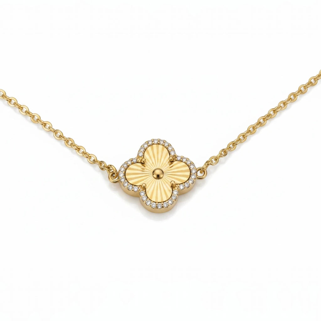 KEVOUR 18K gold-filled clover bracelet featuring a fluted gold charm framed with pavé cubic zirconia on a gold chain.