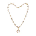 KEVOUR 18K gold-filled station necklace featuring bezel-set clear cubic zirconia crystals and a clover charm pendant.