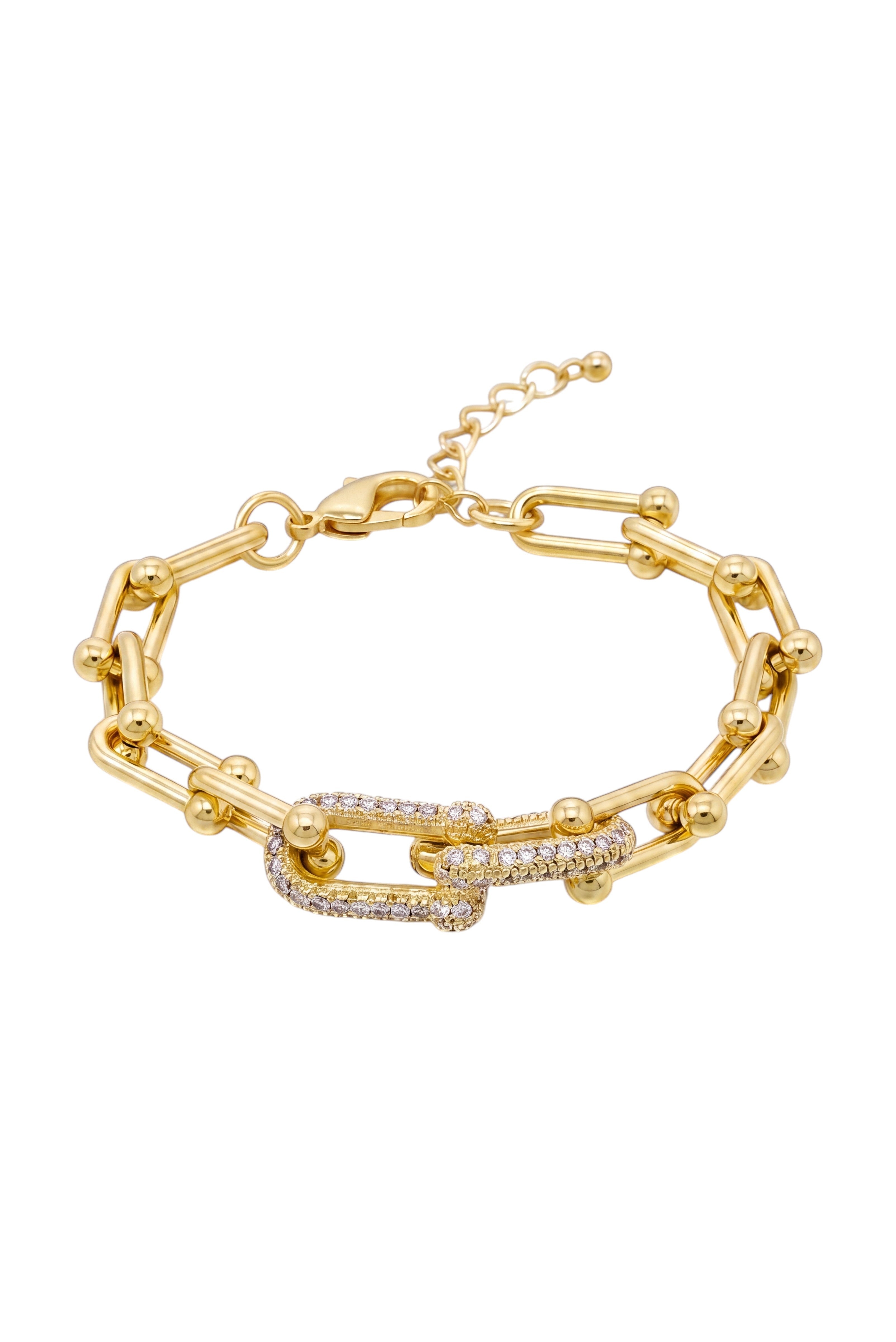KEVOUR gold-tone link chain bracelet featuring a central clasp embellished with shimmering pavé crystals.